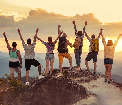 a group of people standing on hill top